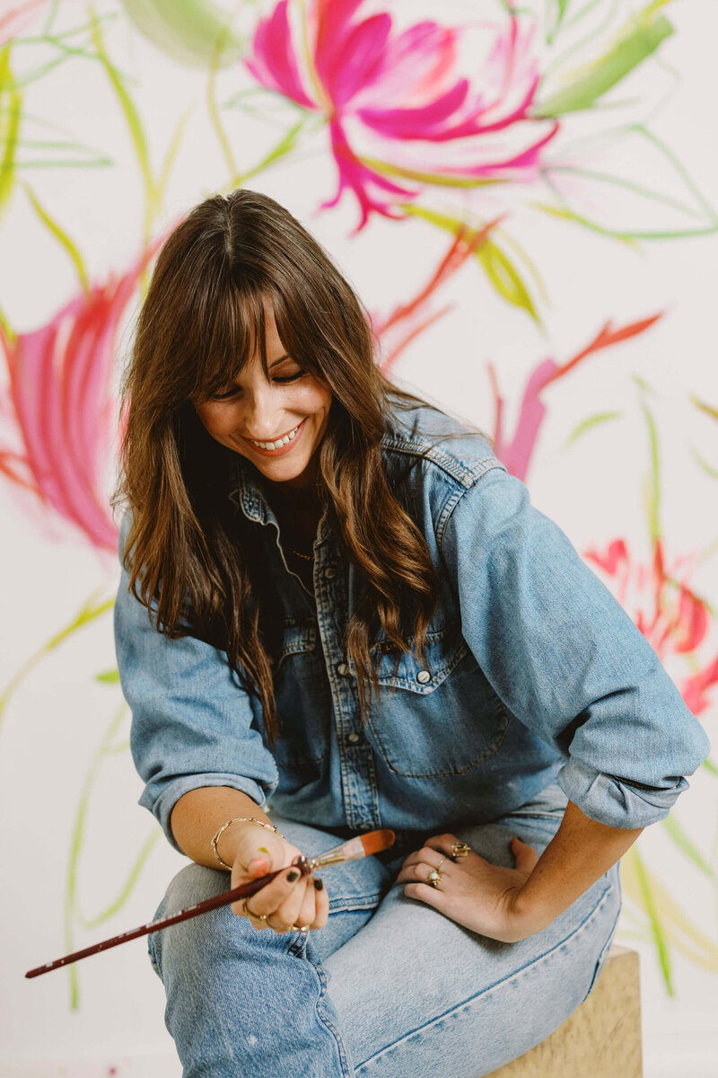 Jenna Rainey reviewing finished paintings